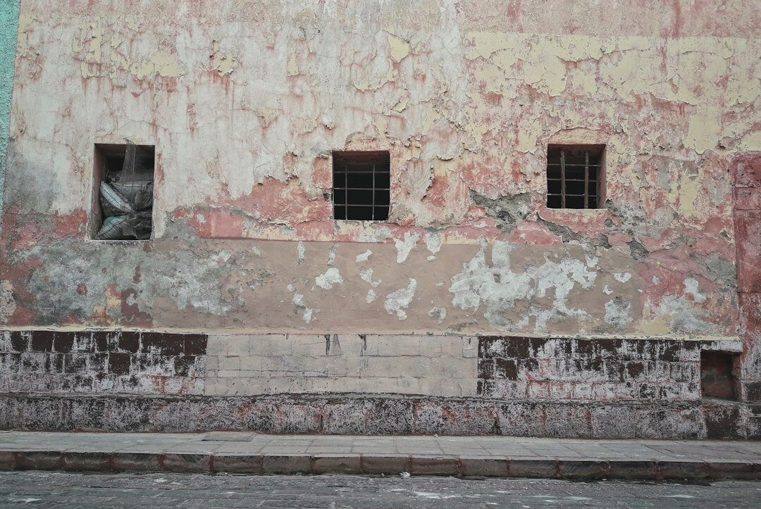 Neglected old building facade with peeling paint in Santiago