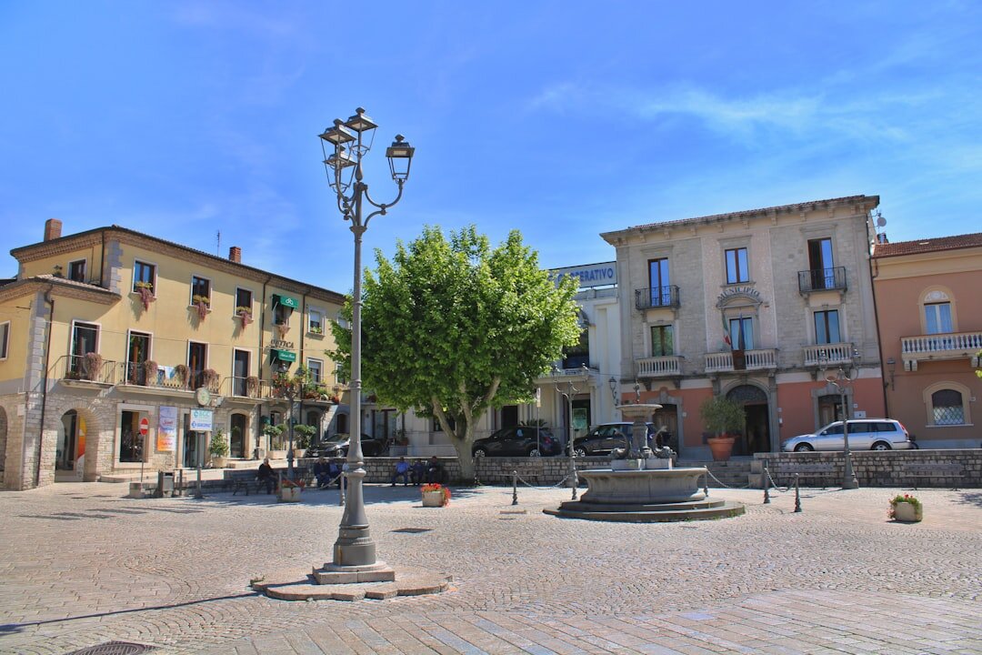 Quiet public plaza with worn benches in a Chilean neighborhood